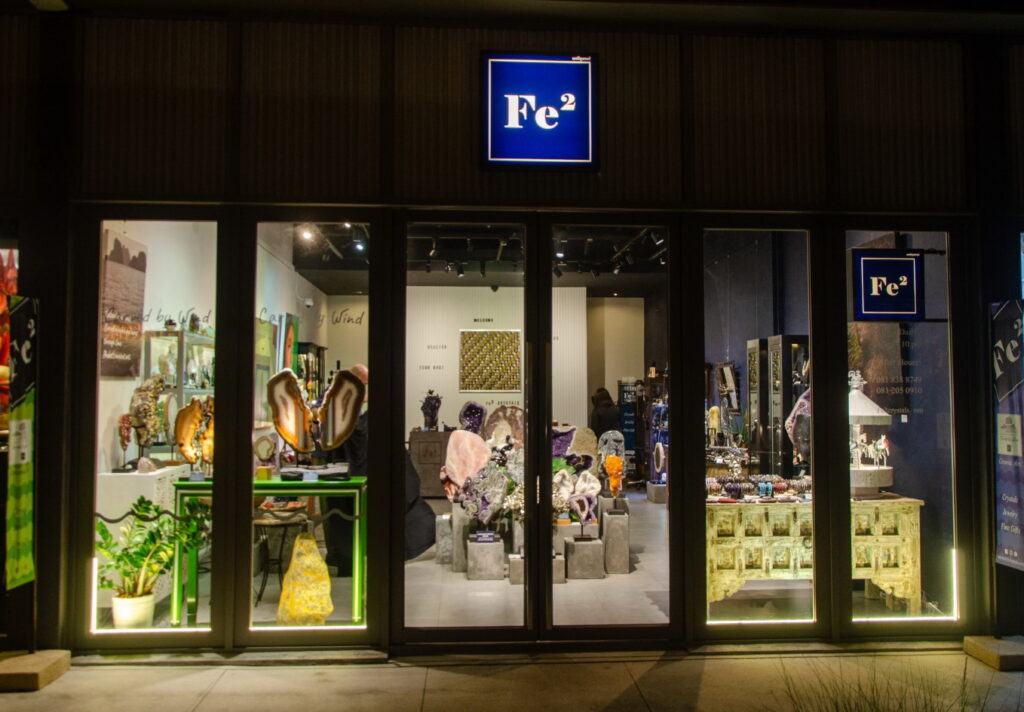 Fe2 Crystal Gallery storefront at Porto de Phuket, lit at night