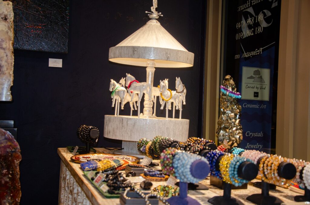 Bead bracelets displayed on stands in the Fe2 Crystals gallery