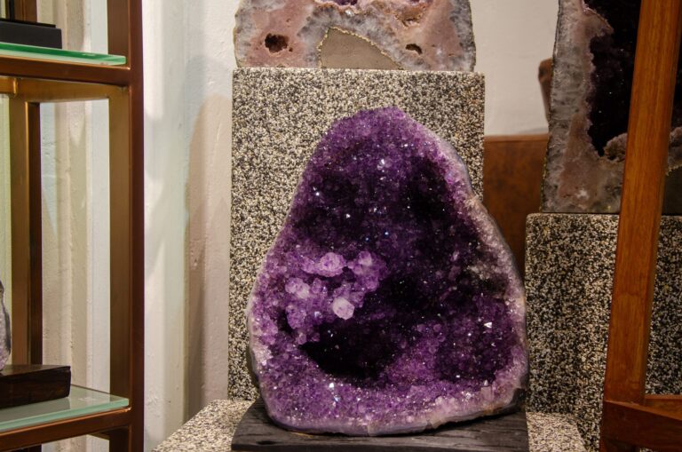 Deep purple amethyst geode in a display case