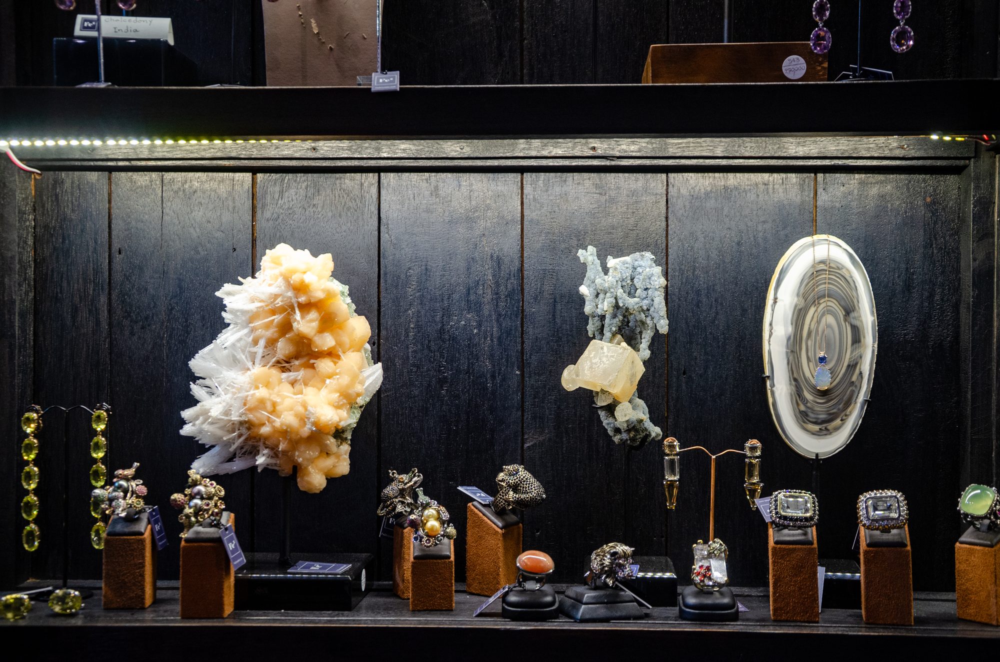 Lit wall display of crystals on stands